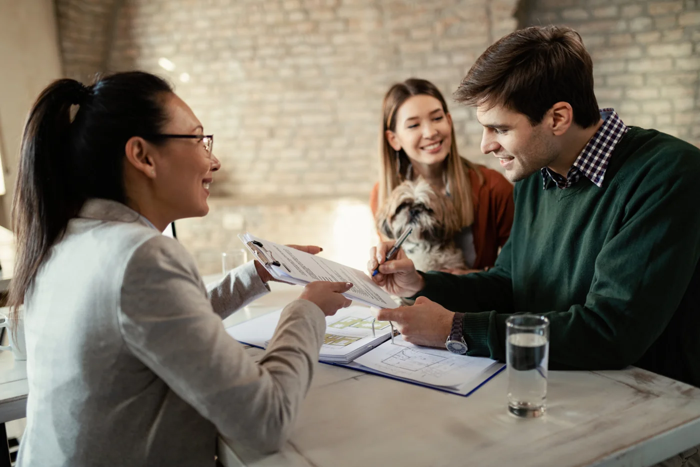 Illustrative photograph of clients signing a property agreement