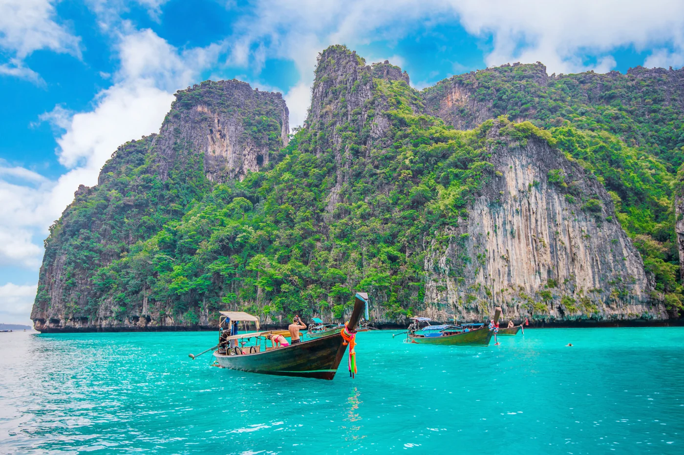 Longtail boats and limestone cliffs in Krabi
